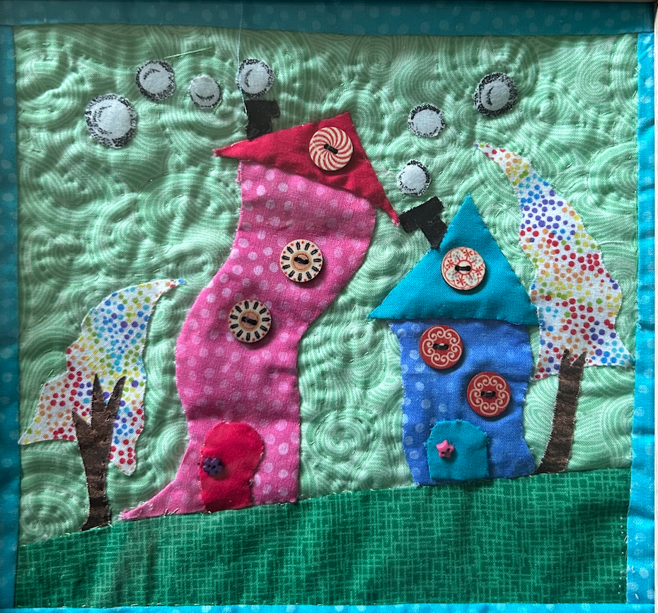 Whimsical storybook houses quilted appliqué wall art in teal frame