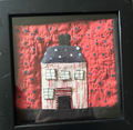 Bold red quilted house appliqué wall art in black shadow box frame