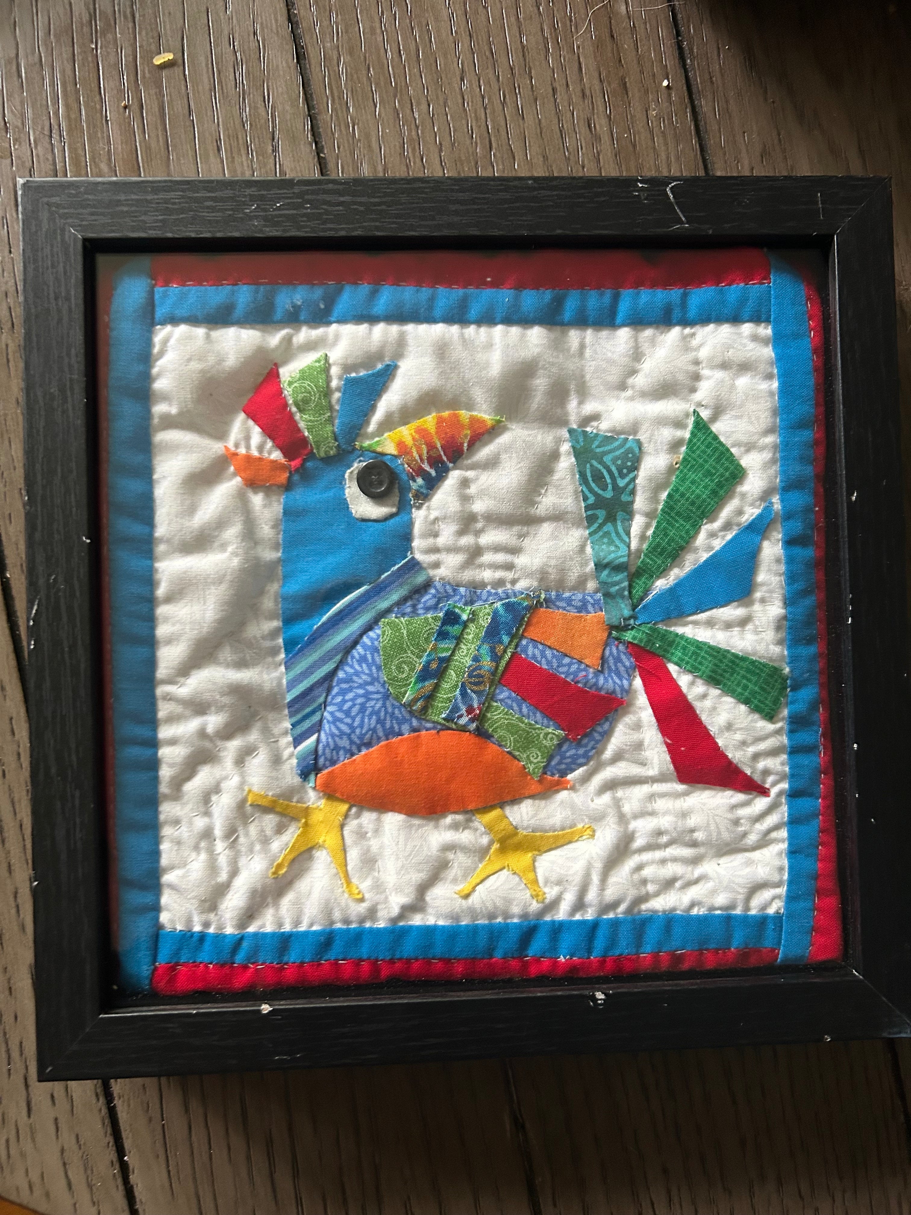 Whimsical quilted bird appliqué wall art in black shadow box frame